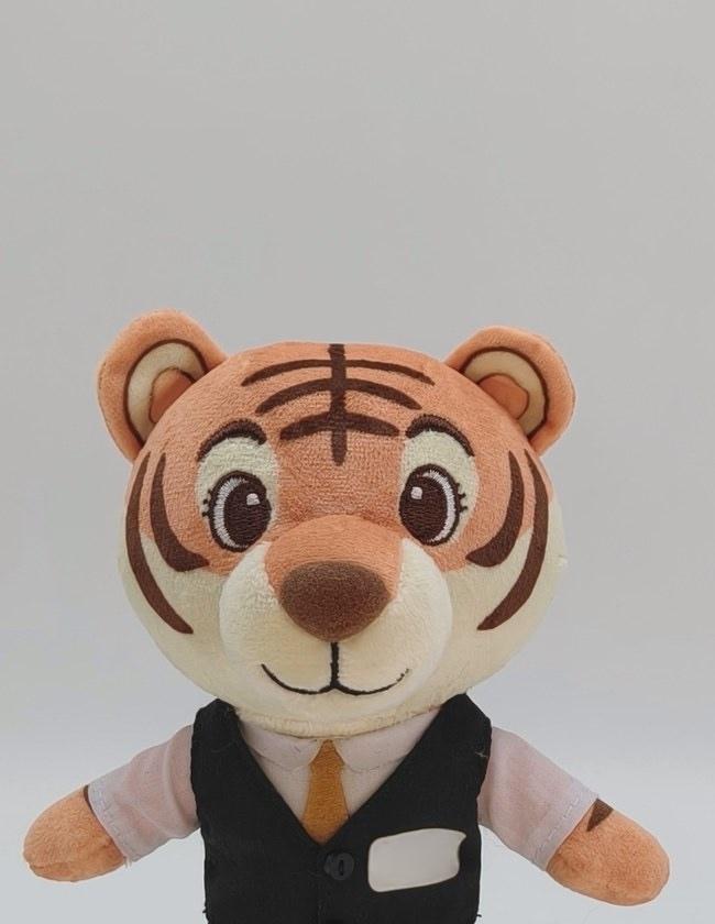 Detail view of the tiger mascot plush sample showing fabric texture and embroidery