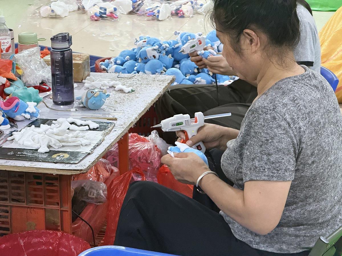 Hand-finishing a plush sample at our workshop